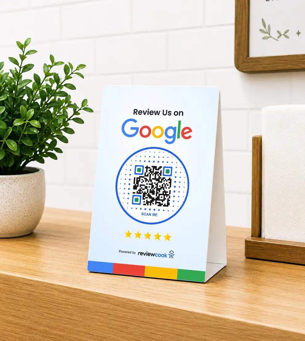 Countertop table tent that reads 'Review Us on Google' with a Scan Me QR code, five stars, and a 'Powered by ReviewCook' label